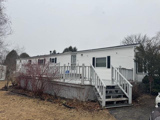 rear view of house featuring a deck