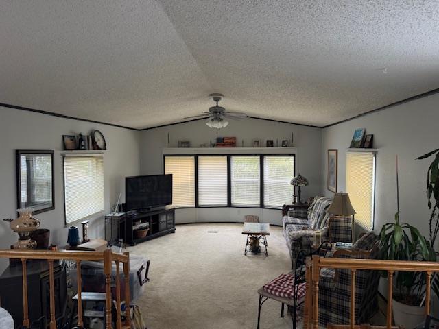 carpeted living room with lofted ceiling, ceiling fan, and a textured ceiling