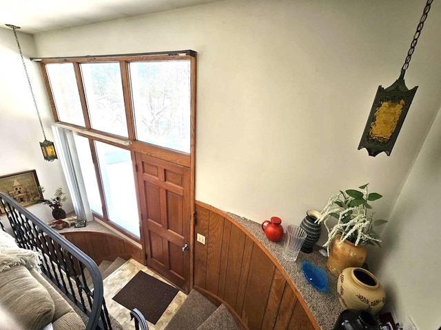 entryway with wood walls and wainscoting