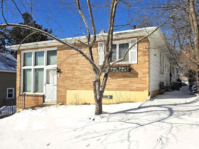 exterior space with brick siding, crawl space, and central AC unit