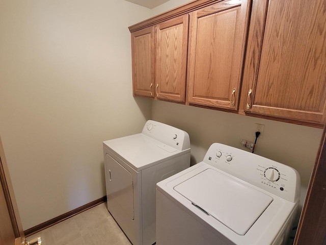 laundry area with cabinet space, baseboards, and separate washer and dryer