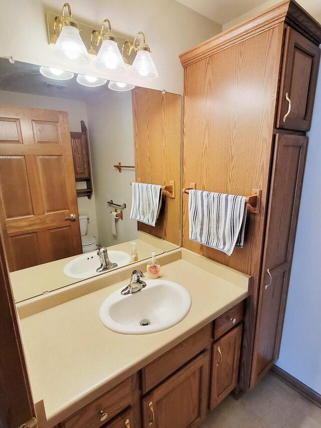 bathroom featuring vanity and toilet