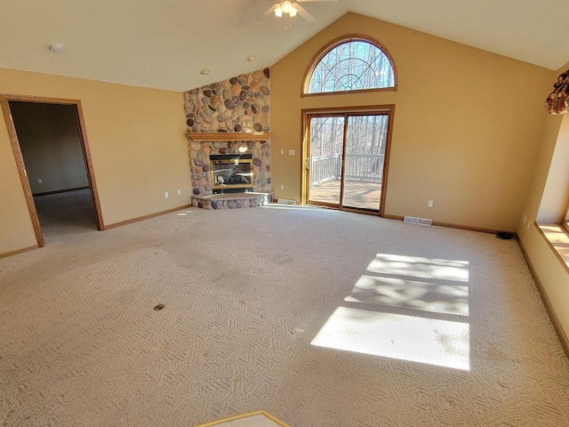 unfurnished living room featuring a stone fireplace, carpet, visible vents, and baseboards