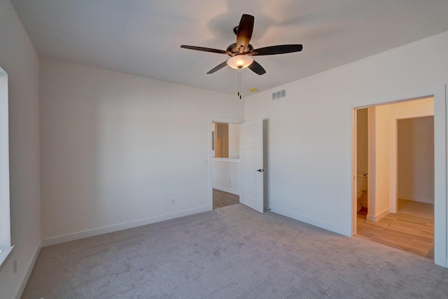 unfurnished bedroom featuring carpet floors, visible vents, and baseboards