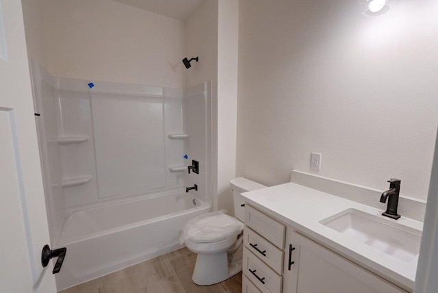 bathroom featuring washtub / shower combination, vanity, and toilet