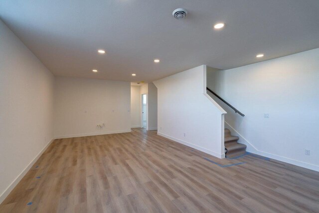 interior space with stairs, light wood-type flooring, baseboards, and recessed lighting