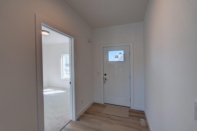 entrance foyer with light wood-style floors and baseboards