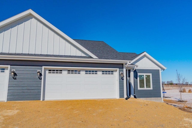 view of front of house with driveway and roof with shingles