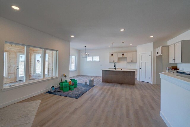 kitchen featuring light wood finished floors, baseboards, and recessed lighting