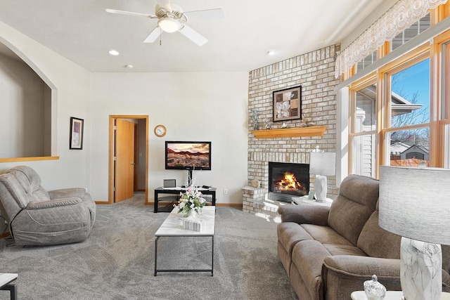 living room with ceiling fan, recessed lighting, carpet flooring, baseboards, and a brick fireplace