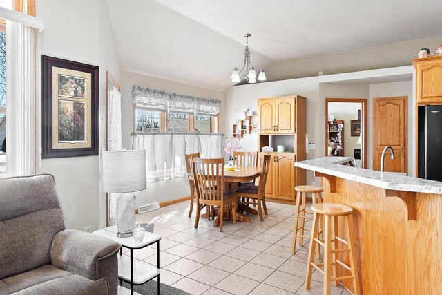 dining room featuring light tile patterned floors, baseboards, visible vents, lofted ceiling, and a chandelier