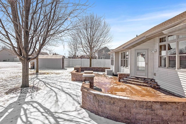 view of yard featuring an outbuilding, central air condition unit, a storage unit, entry steps, and fence