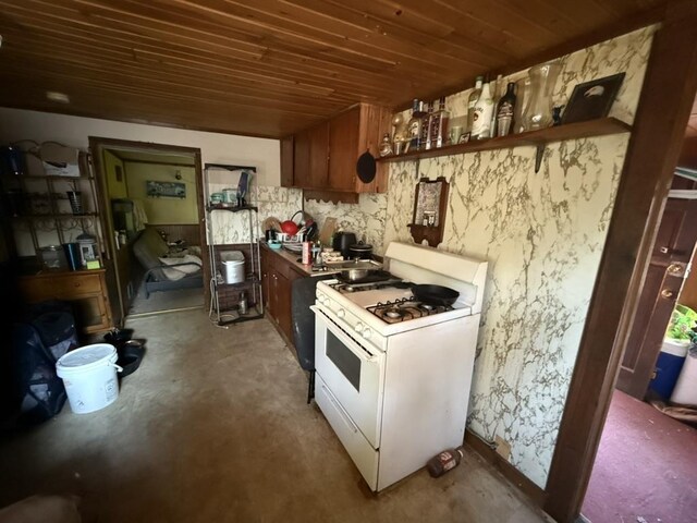 kitchen featuring concrete floors, wooden ceiling, white gas stove, and open shelves