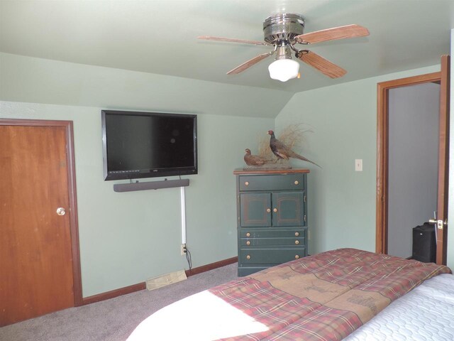 carpeted bedroom with baseboards, lofted ceiling, and ceiling fan