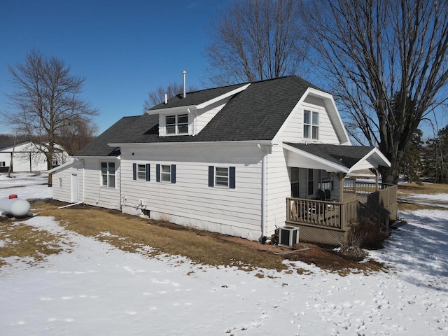 exterior space featuring cooling unit, a wooden deck, and a shingled roof