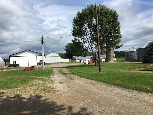 view of road with an outbuilding and dirt driveway