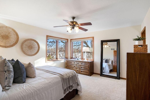 bedroom with light carpet, ceiling fan, and baseboards