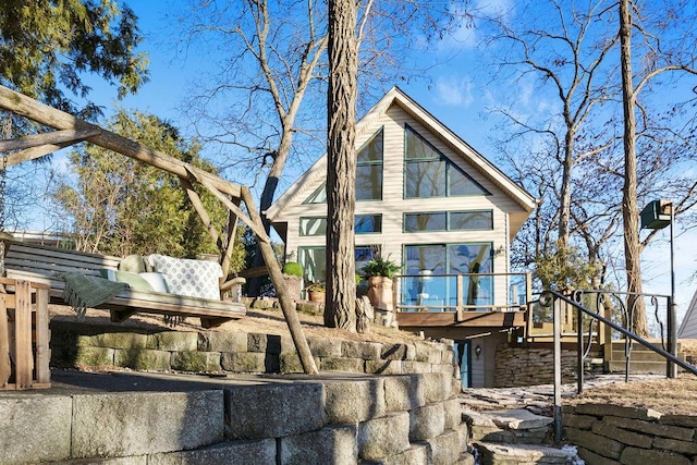 back of house with a deck and stairway