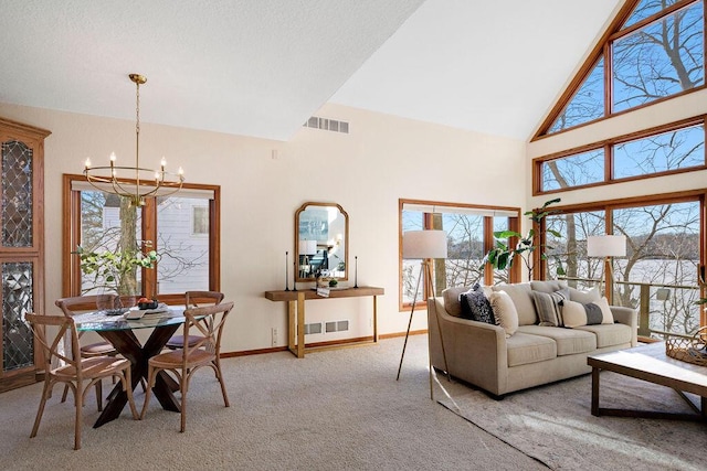 living area with carpet floors, visible vents, a notable chandelier, and baseboards