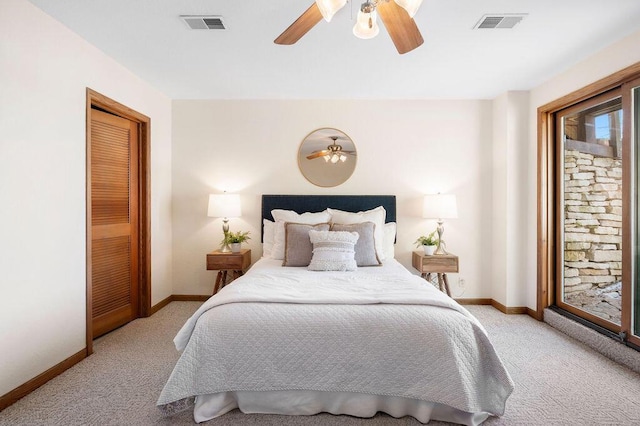 carpeted bedroom with access to outside, visible vents, and baseboards