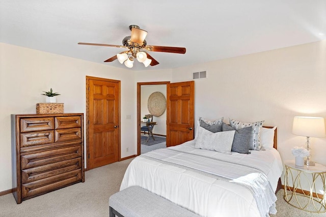 bedroom featuring light carpet, a ceiling fan, visible vents, and baseboards