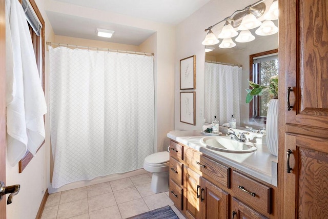 bathroom with a shower with curtain, vanity, toilet, and tile patterned floors