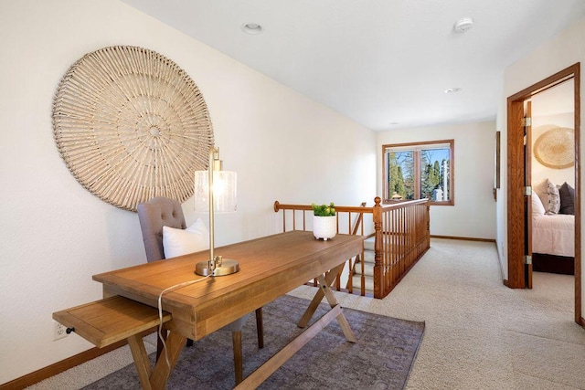 home office featuring baseboards and light colored carpet