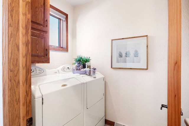 laundry area featuring cabinet space and independent washer and dryer