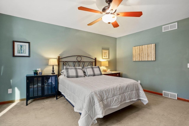 carpeted bedroom with baseboards, visible vents, and a ceiling fan