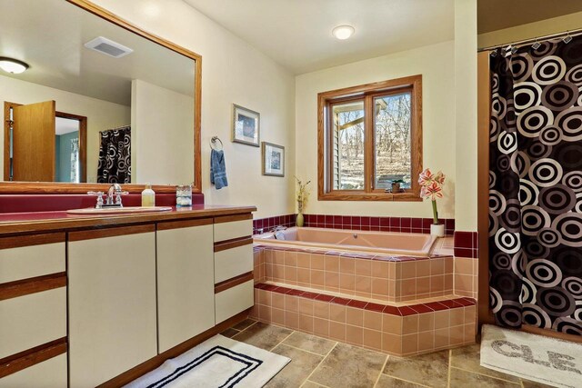 bathroom with curtained shower, visible vents, vanity, and a bath