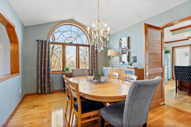 dining area featuring lofted ceiling, an inviting chandelier, baseboards, and light wood-style floors