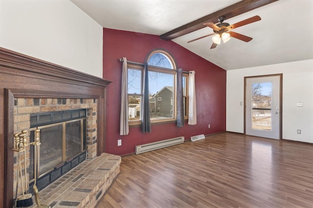 unfurnished living room with a baseboard heating unit, plenty of natural light, and wood finished floors