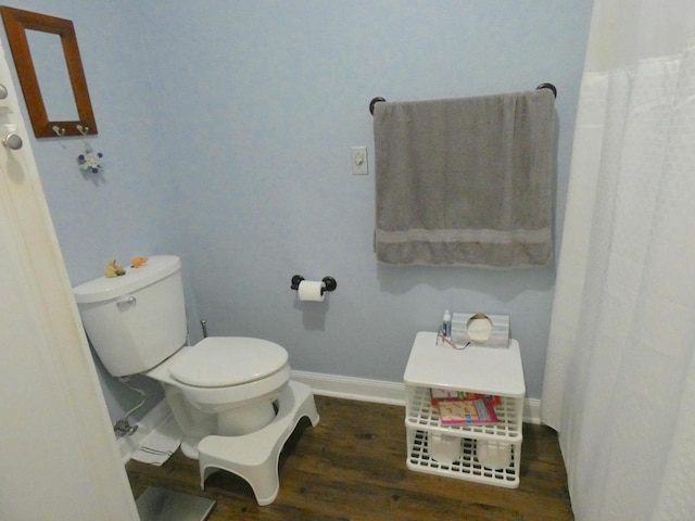 full bathroom with toilet, baseboards, and wood finished floors