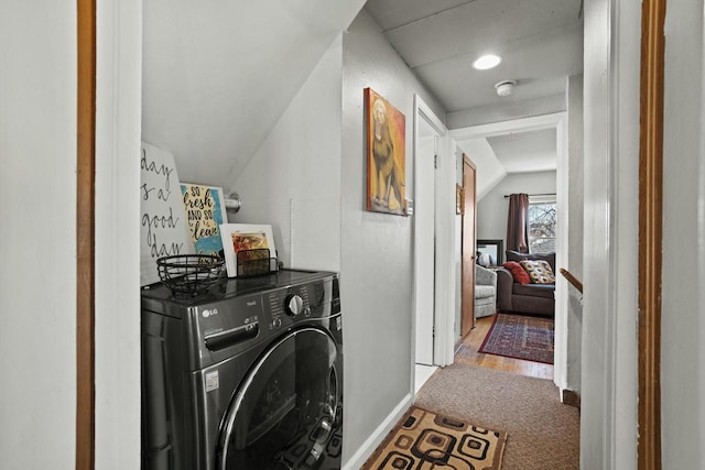 washroom featuring laundry area, carpet, washer / dryer, and baseboards