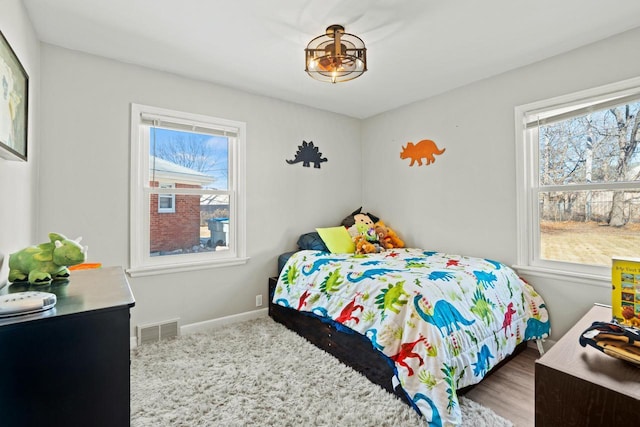 bedroom with visible vents and baseboards