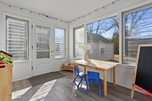 office featuring wood finished floors and a sunroom