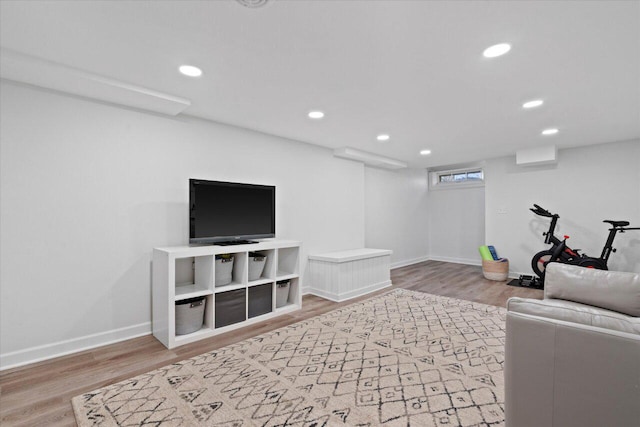 living room with recessed lighting, baseboards, and wood finished floors