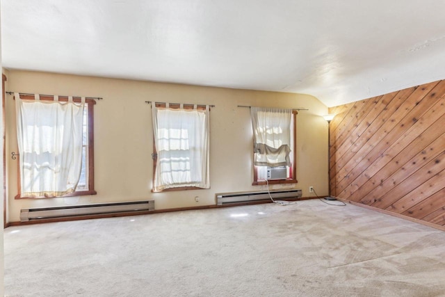 empty room with carpet floors, a baseboard radiator, cooling unit, and wood walls