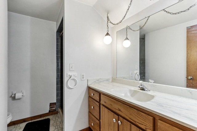 full bathroom with toilet, a stall shower, vanity, baseboards, and tile patterned floors