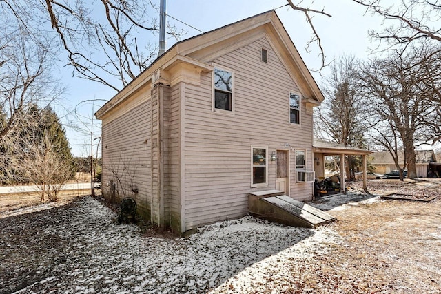 rear view of house featuring cooling unit