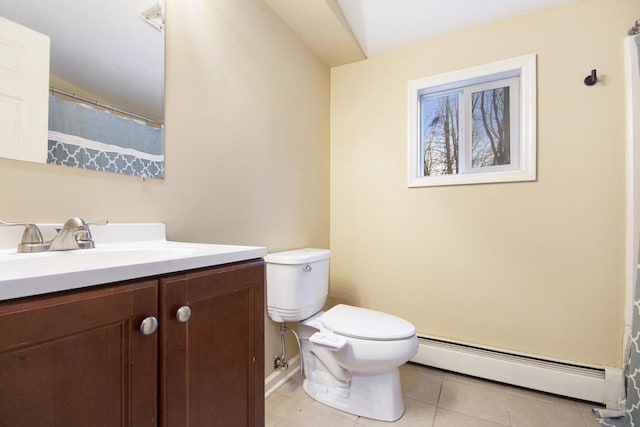 bathroom with toilet, a baseboard heating unit, vanity, baseboards, and tile patterned floors