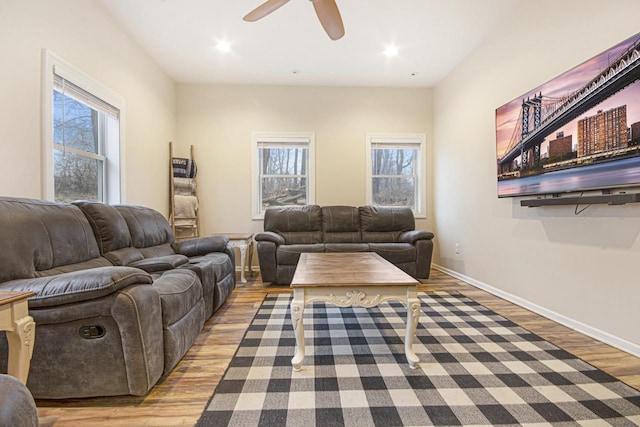 living area featuring a ceiling fan, recessed lighting, baseboards, and wood finished floors