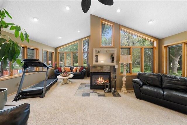 carpeted living room with lofted ceiling, a fireplace, a textured ceiling, and recessed lighting