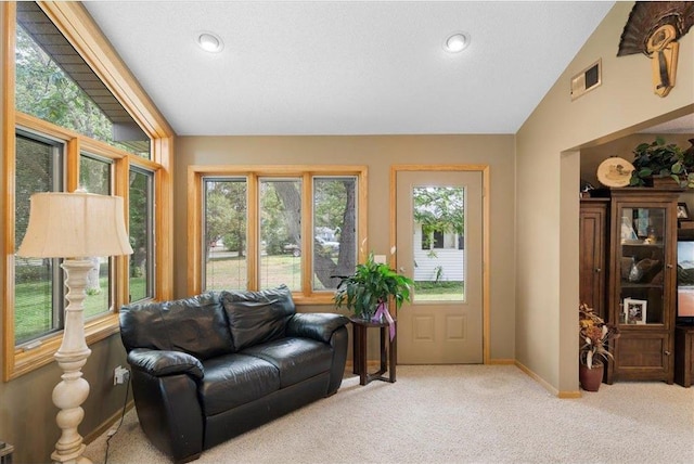 living area with recessed lighting, light colored carpet, visible vents, baseboards, and vaulted ceiling