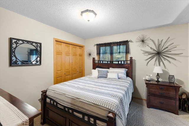 bedroom with a textured ceiling, a closet, and baseboards