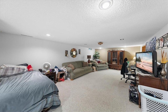 bedroom with a textured ceiling and recessed lighting