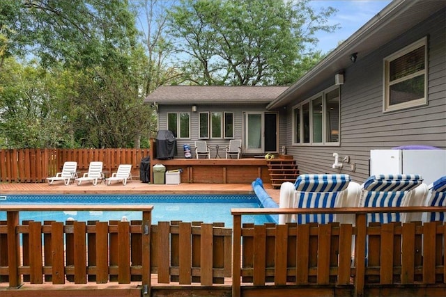 view of pool with a fenced in pool, a grill, and fence