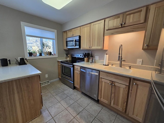 kitchen with light tile patterned floors, visible vents, stainless steel appliances, light countertops, and a sink