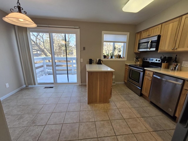 kitchen featuring stainless steel appliances, light countertops, visible vents, and light tile patterned floors