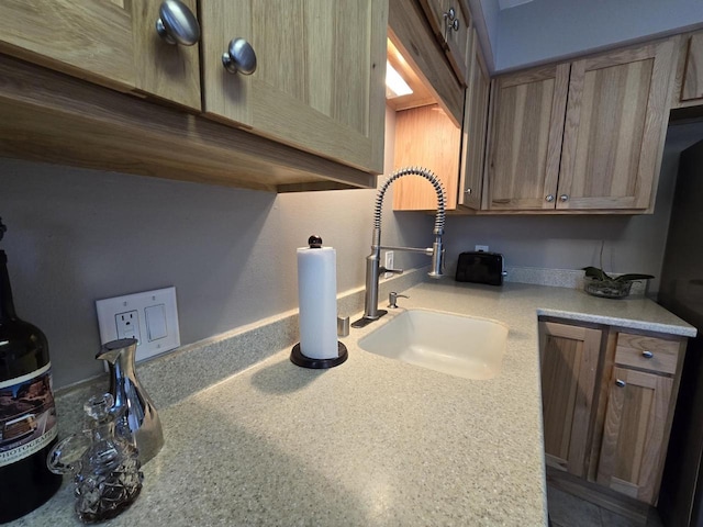 kitchen featuring light countertops and a sink